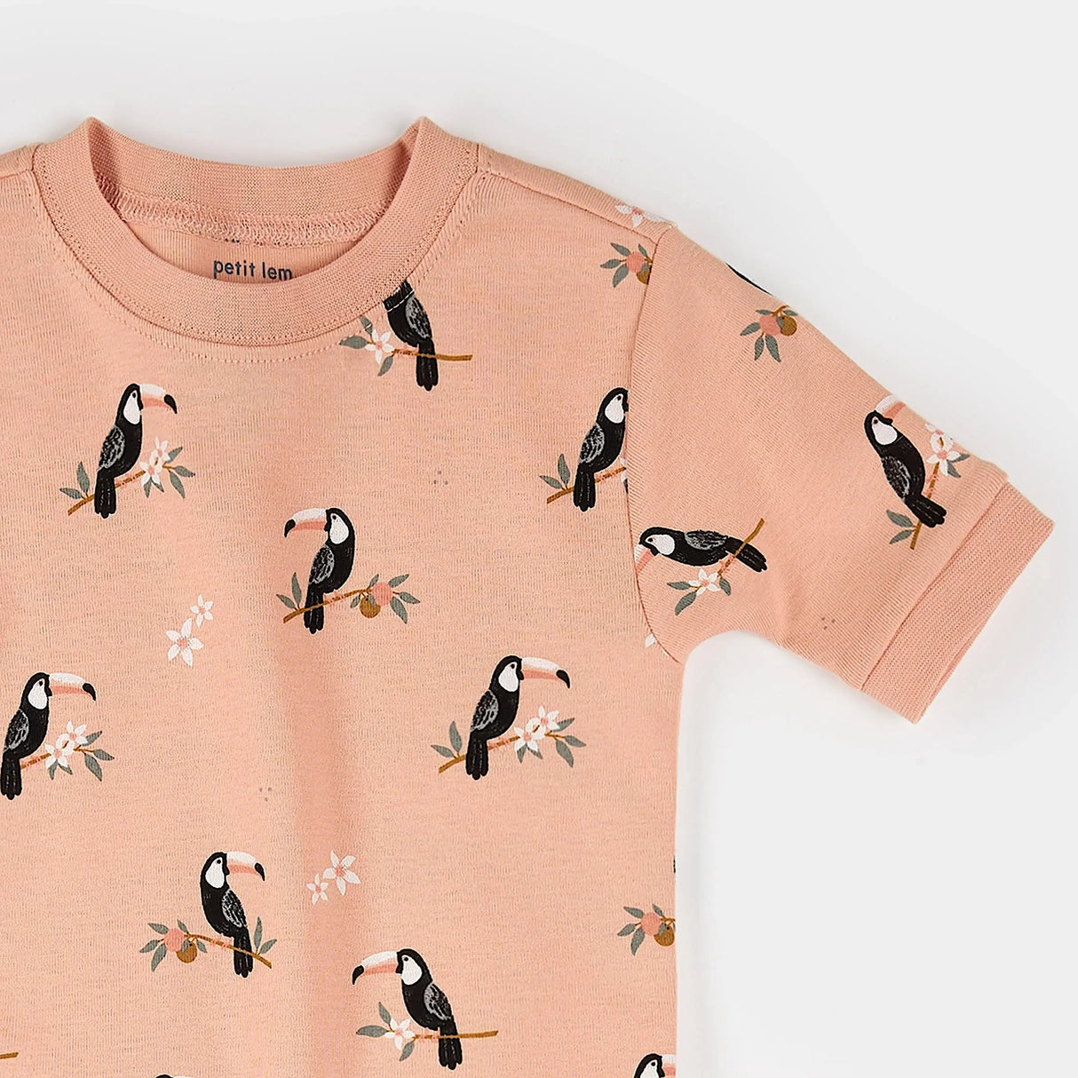 Close-up of toucan print organic cotton fabric on kids summer pajama set