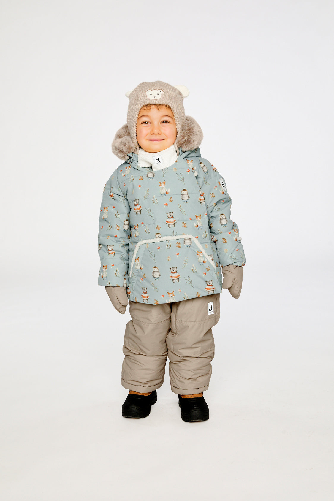 Baby wearing the Deux par Deux baby two-piece snowsuit in Blue Animal Print in a winter lookbook view