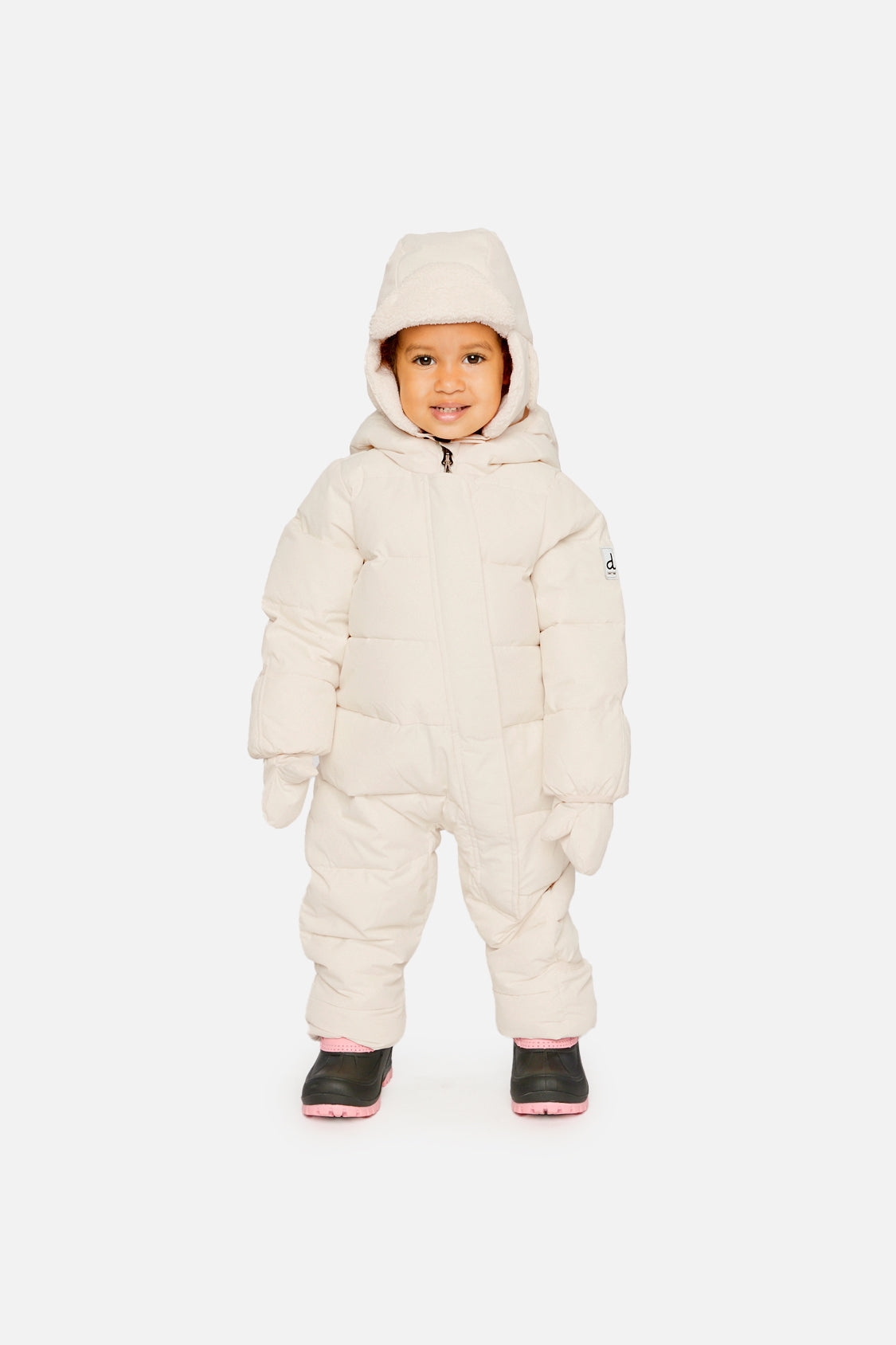 Baby wearing off-white Deux par Deux Baby Cloud snowsuit in winter