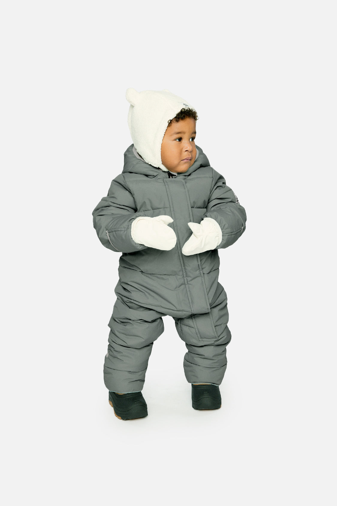 Baby boy wearing Deux par Deux Sage Green Baby Cloud snowsuit with fleece-lined hood
