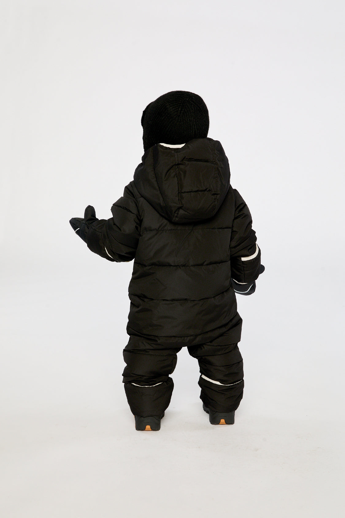Baby boy in Black Deux par Deux Baby Cloud snowsuit with fold-over mittens and footies