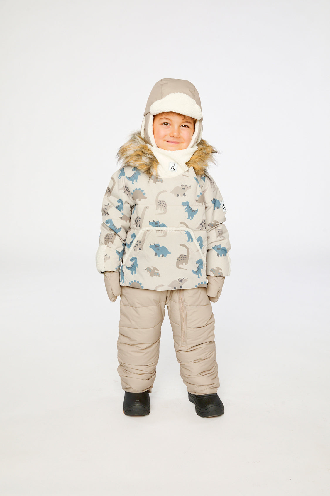 Baby boy wearing Deux par Deux Blue Dinosaur Baby Snug snowsuit with faux fur hood