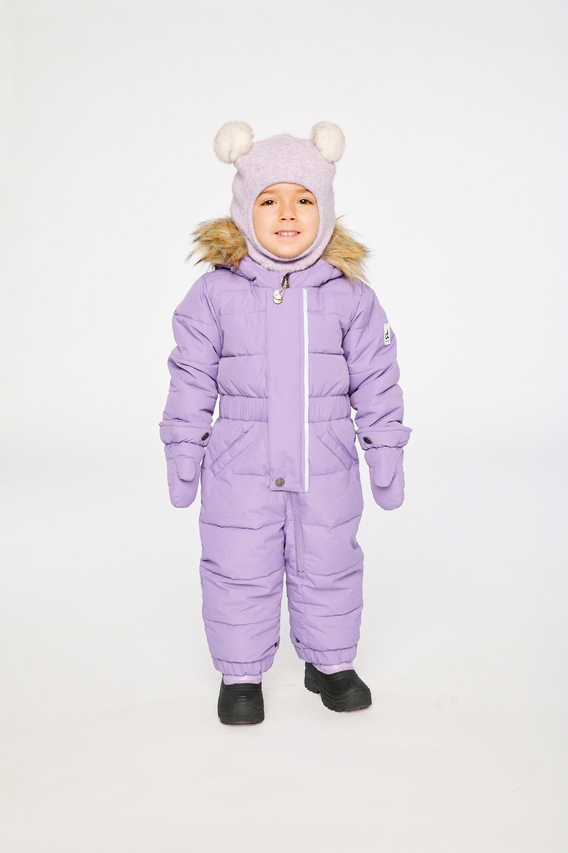 Baby wearing the Deux par Deux Baby Original puffy one-piece snowsuit in Violet in a winter lookbook view