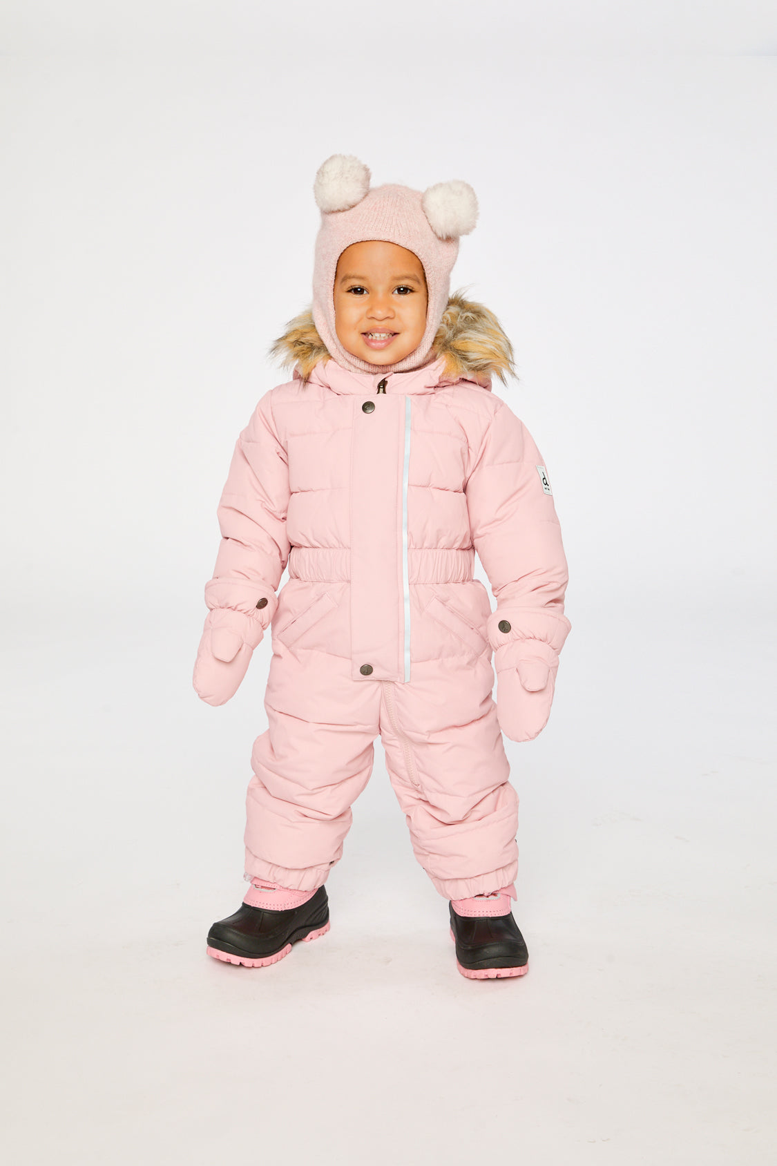 Baby girl wearing Deux par Deux Pale Dusty Pink one-piece puffy winter snowsuit