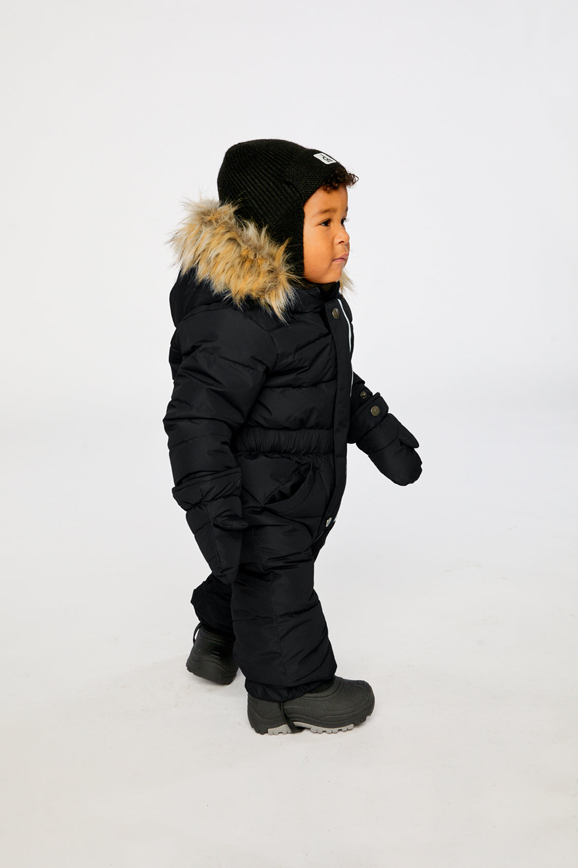 Deux par Deux Baby Original puffy one-piece snowsuit in Black shown from an alternate modeled winter angle