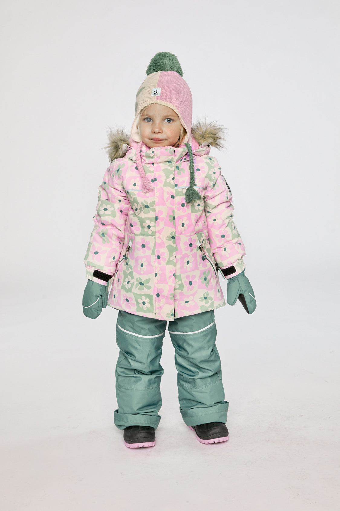 Girl wearing Deux par Deux white and retro pink DISCOVER winter snowsuit
