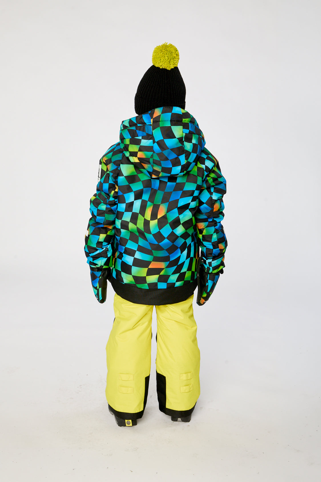Alternate winter lookbook view of the Deux par Deux PLAY two-piece snowsuit in Green Yellow and Blue Checkerboard with Yellow Pants