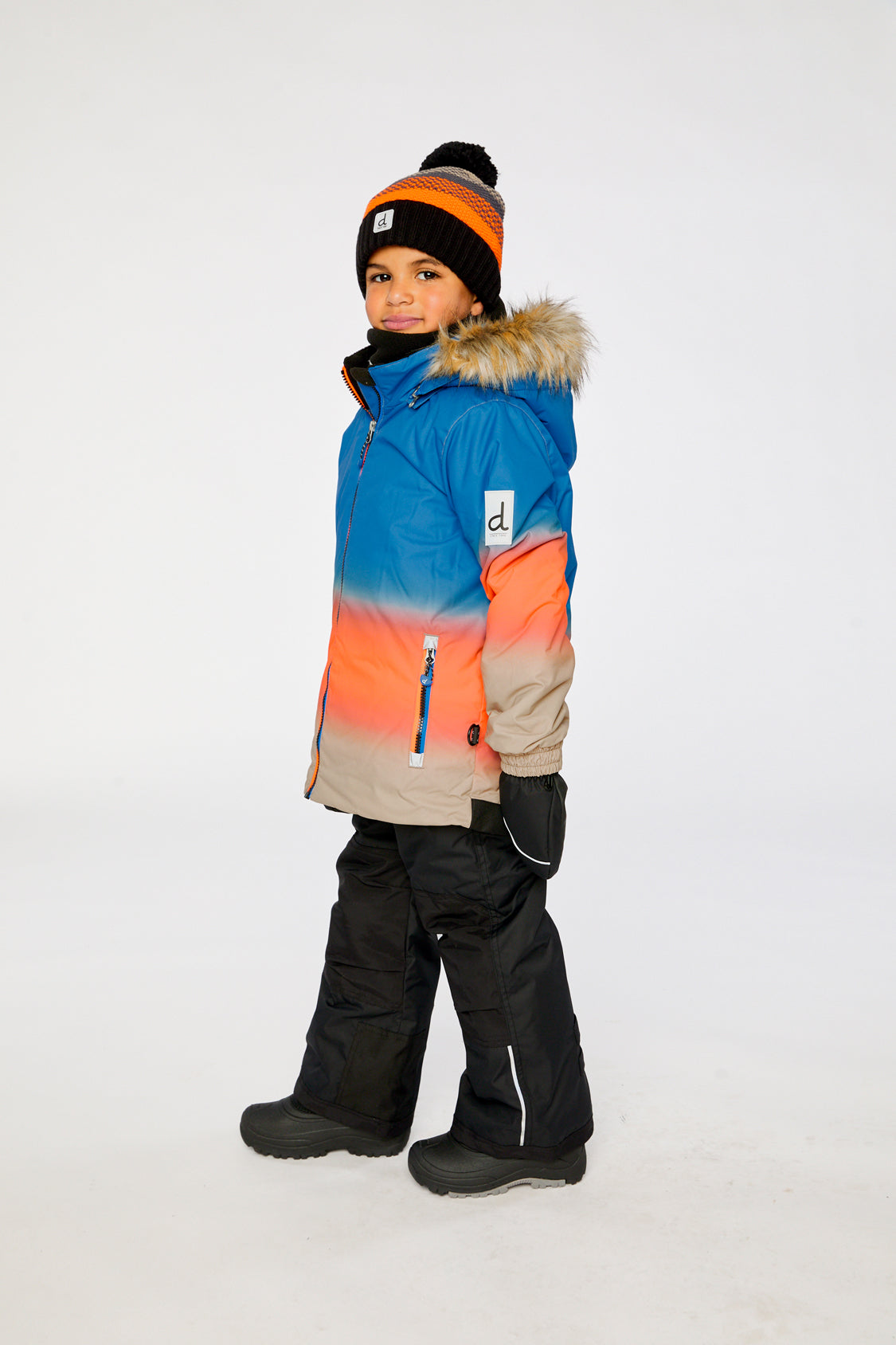 Deux par Deux PLAY two-piece snowsuit in Blue and Orange Gradient shown from an alternate modeled winter angle