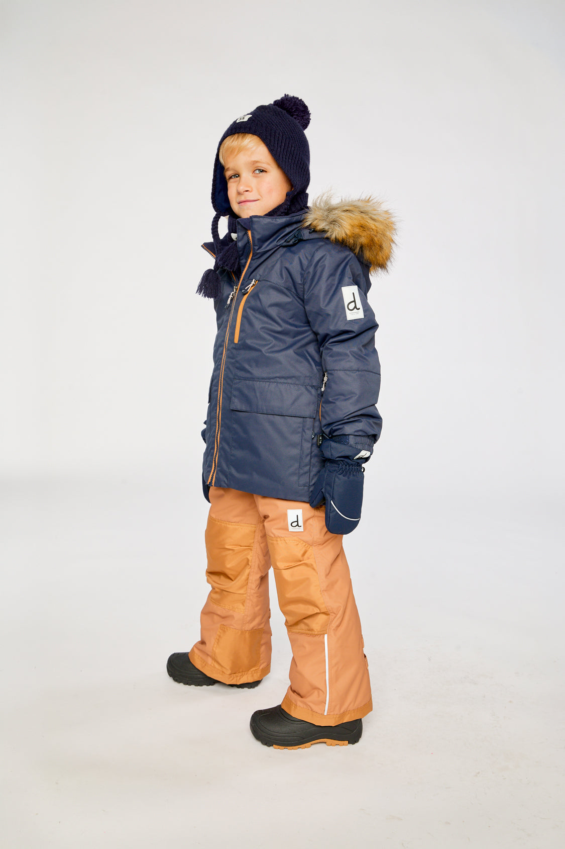 Alternate winter lookbook view of the Deux par Deux PLAY two-piece snowsuit in Navy Blue with Brown Pants
