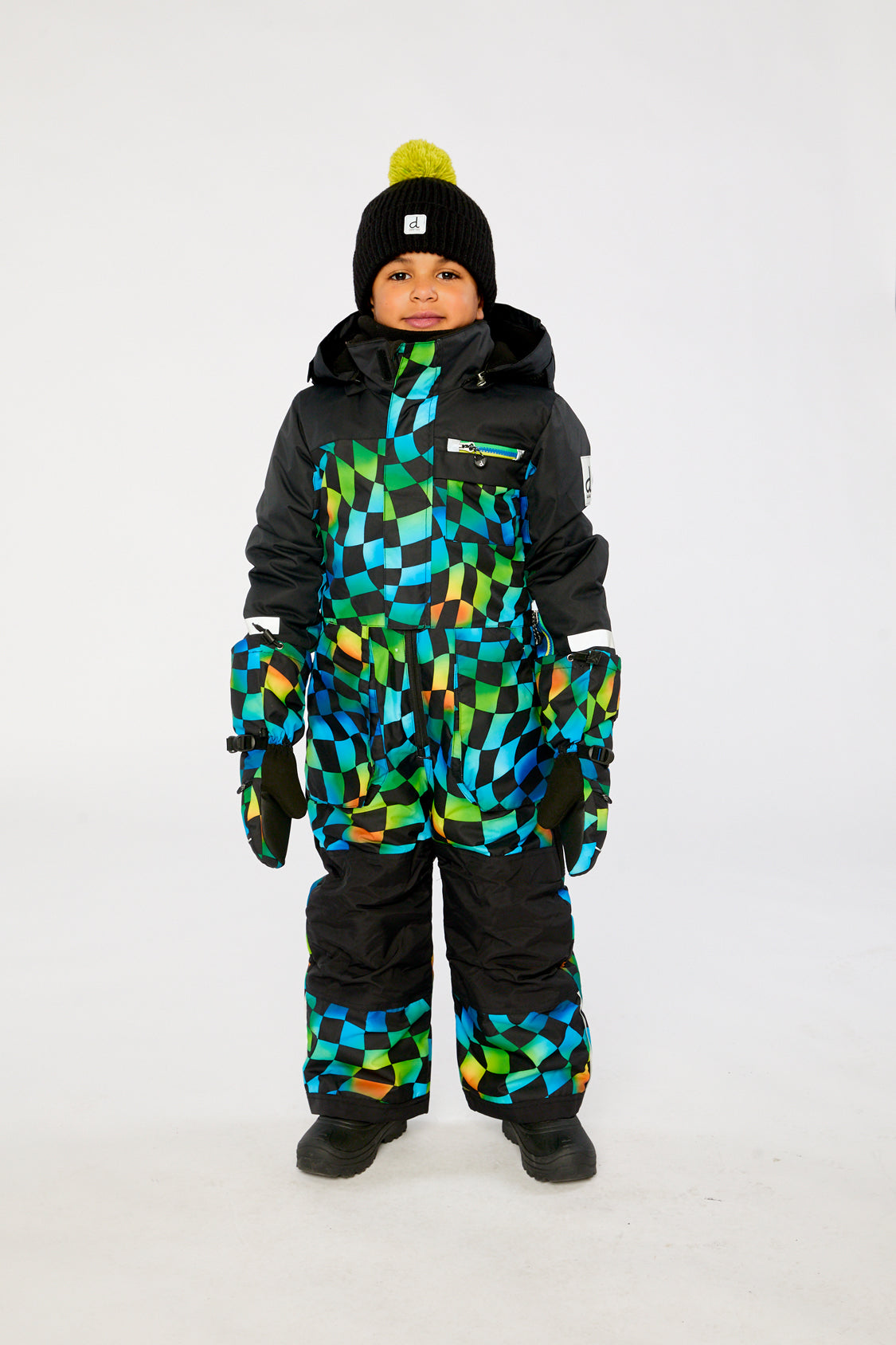 Child wearing the Deux par Deux kids PLAY one-piece snowsuit in Blue Checkered Print in a winter lookbook view