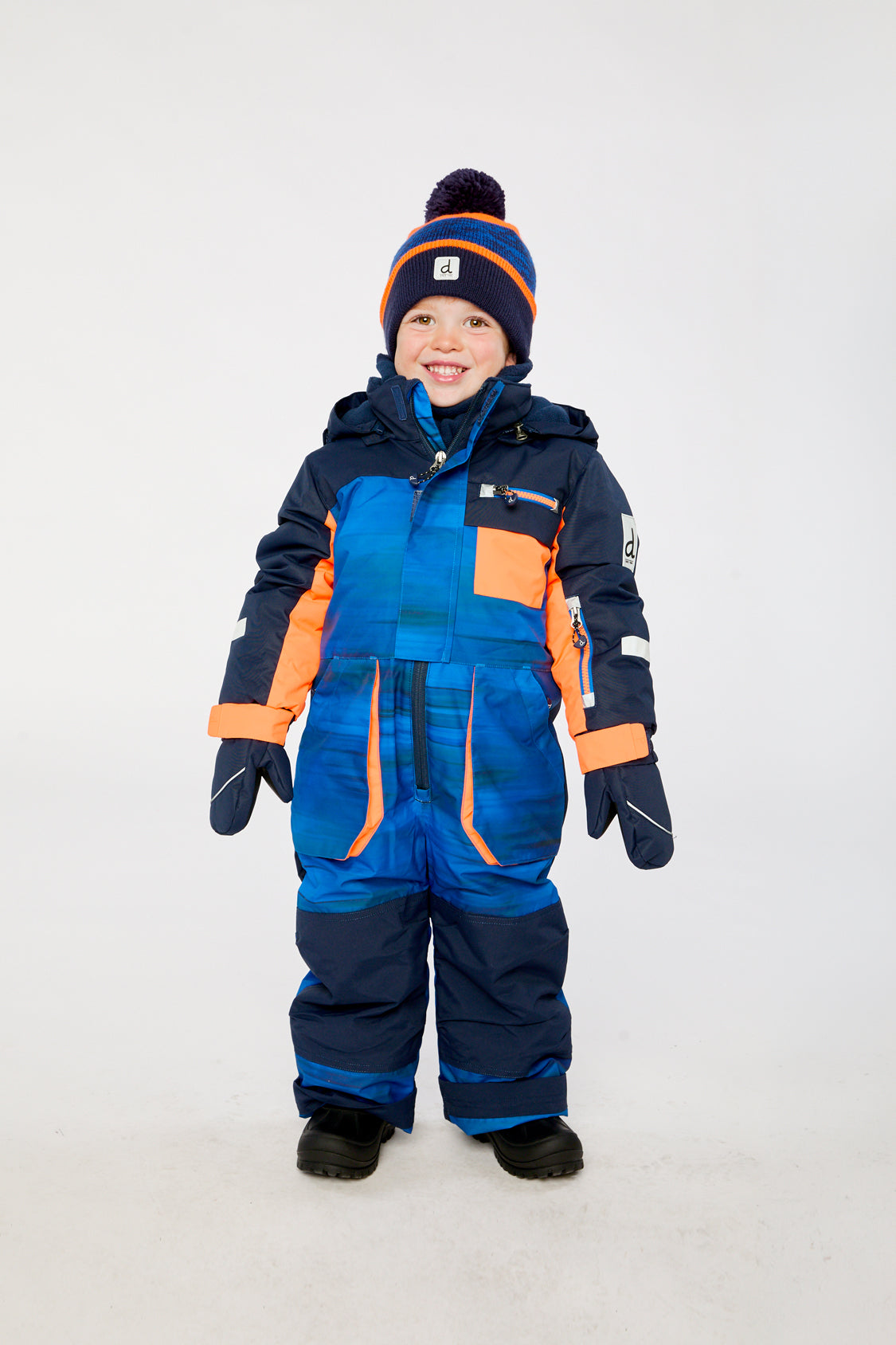 Kids PLAY blue snowsuit with black stripes shown in a modeled winter lookbook view