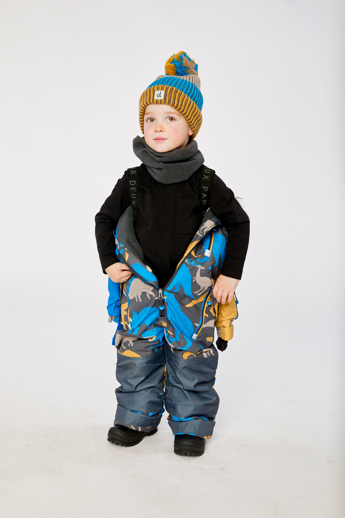 Deux par Deux boys grey blue dinosaur one-piece snowsuit modeled outdoors