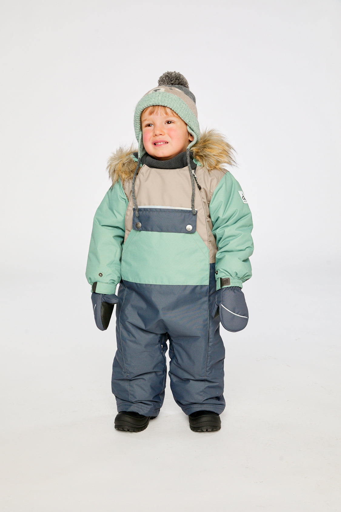 Baby wearing the Deux par Deux baby car-seat one-piece snowsuit in Cool Dark Grey in a winter lookbook view