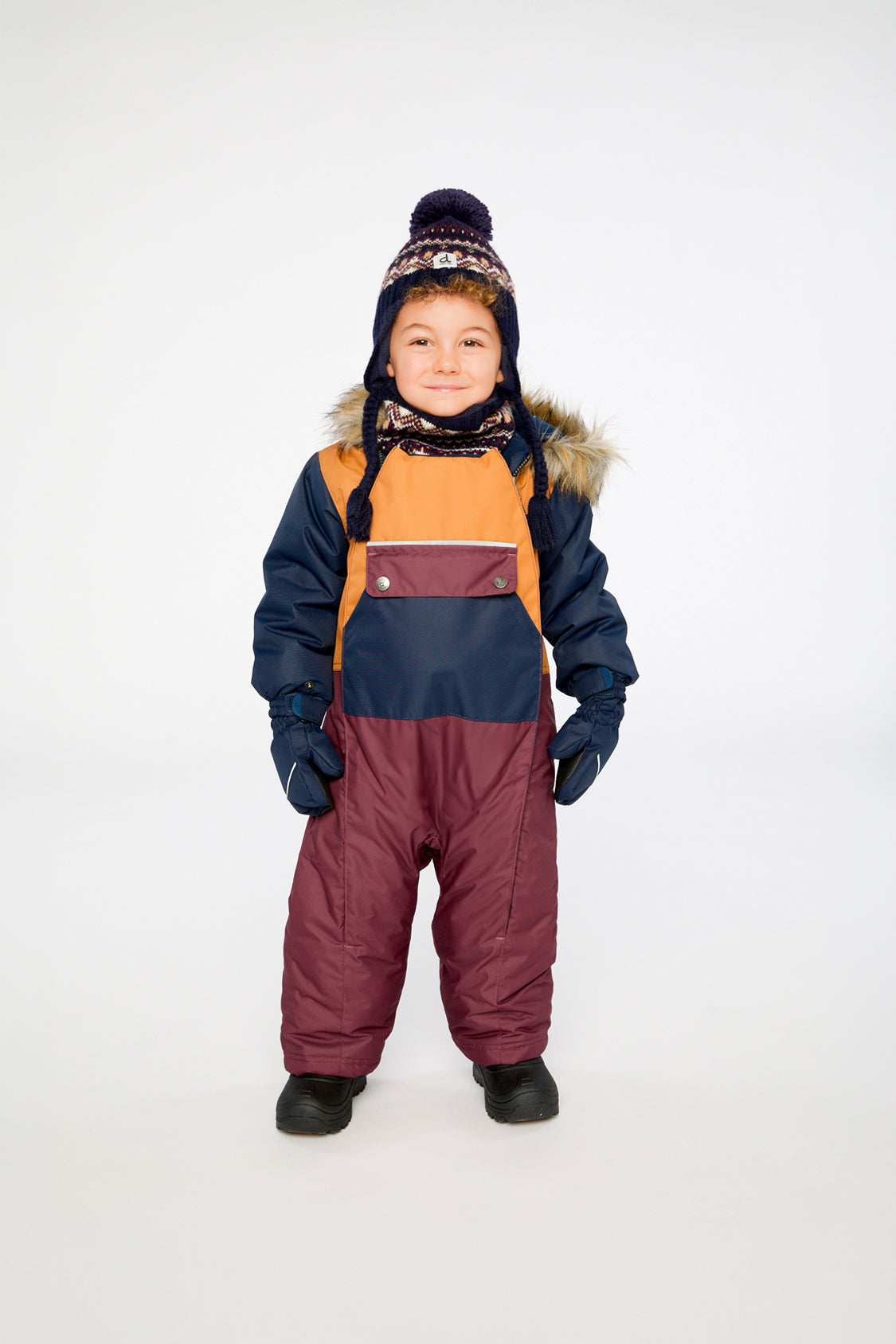 Baby wearing the Deux par Deux baby car-seat one-piece snowsuit in Burgundy in a winter lookbook view