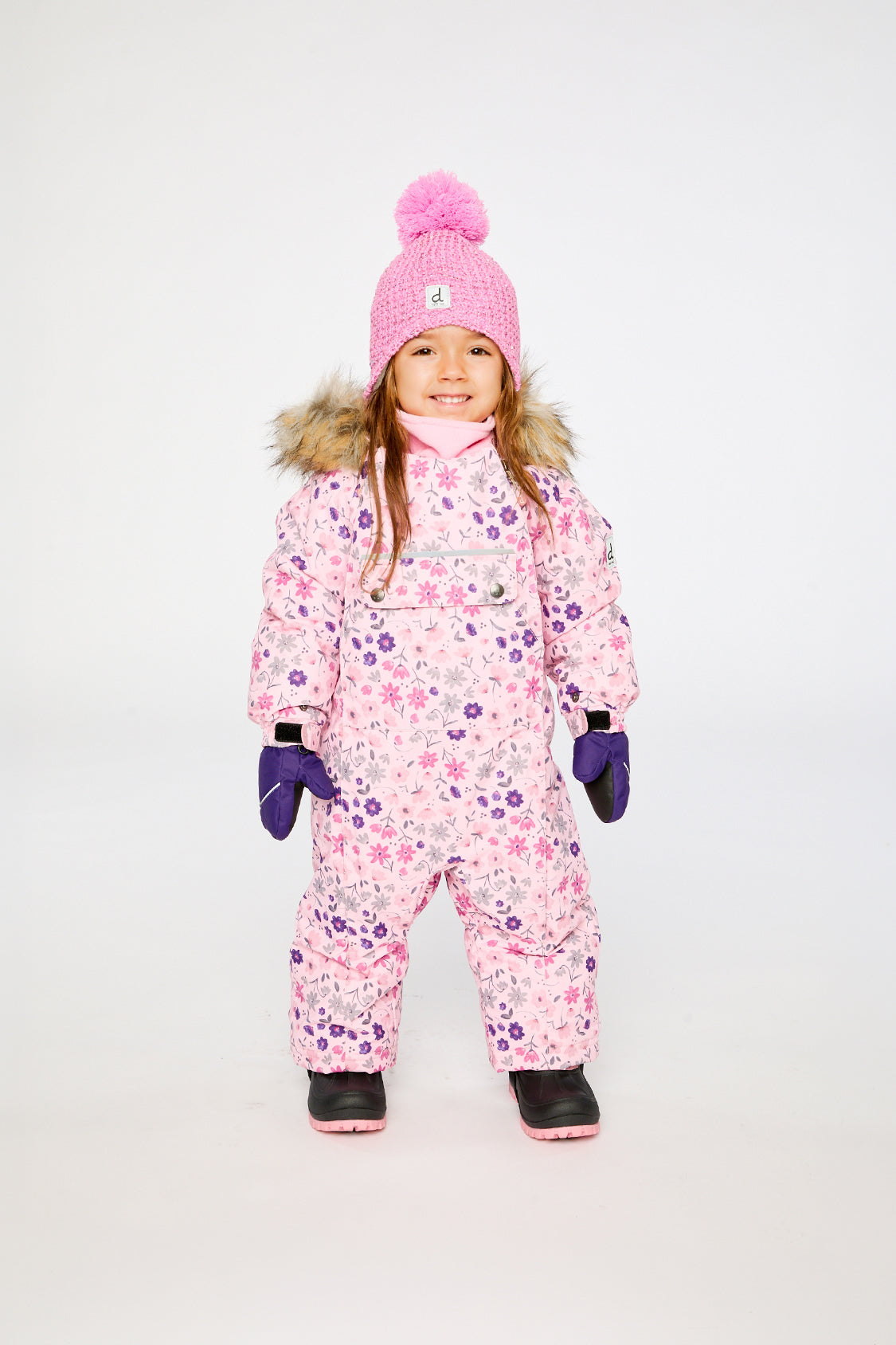 Baby wearing the Deux par Deux pink mini flower car-seat snowsuit in a winter lookbook view