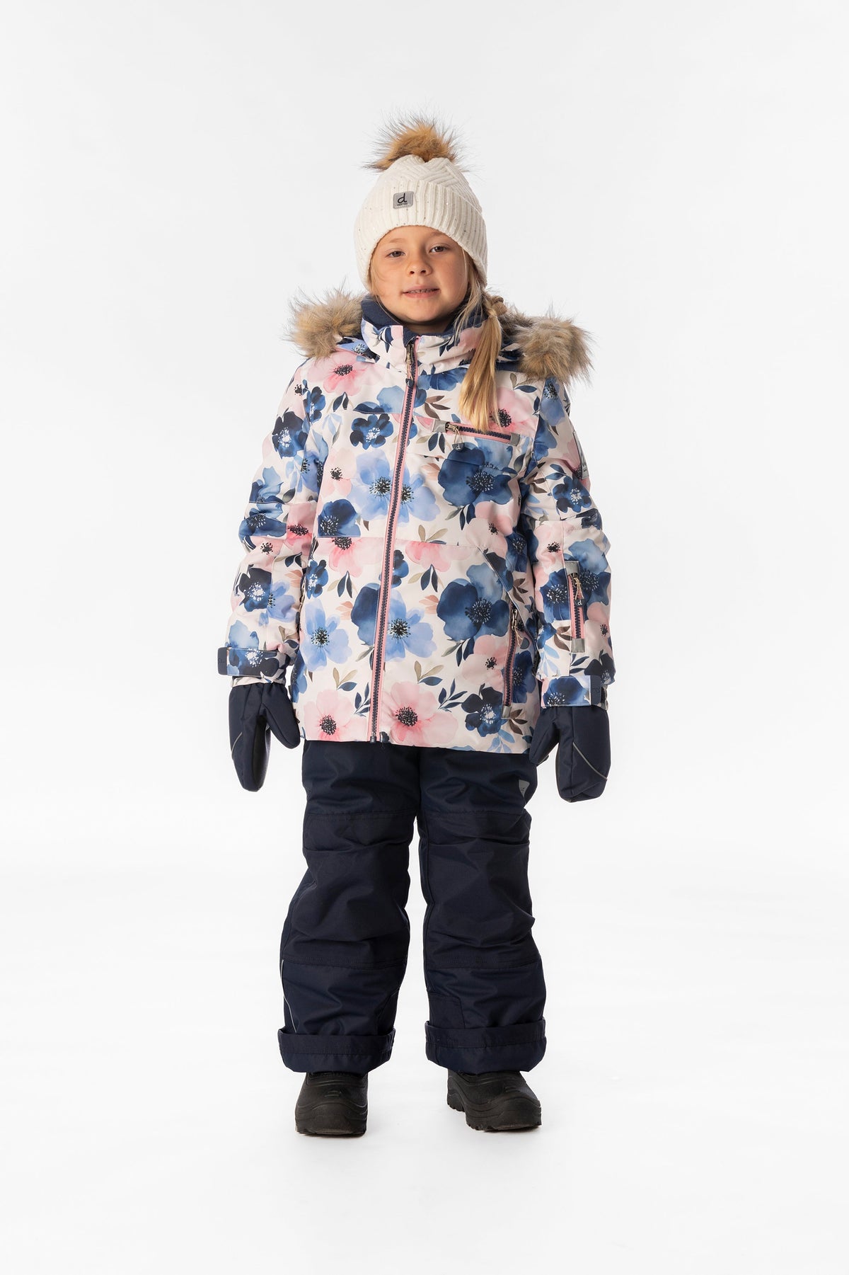 Girl standing in the Deux par Deux PLAY snowsuit with watercolor flower jacket and navy snow pants, front view