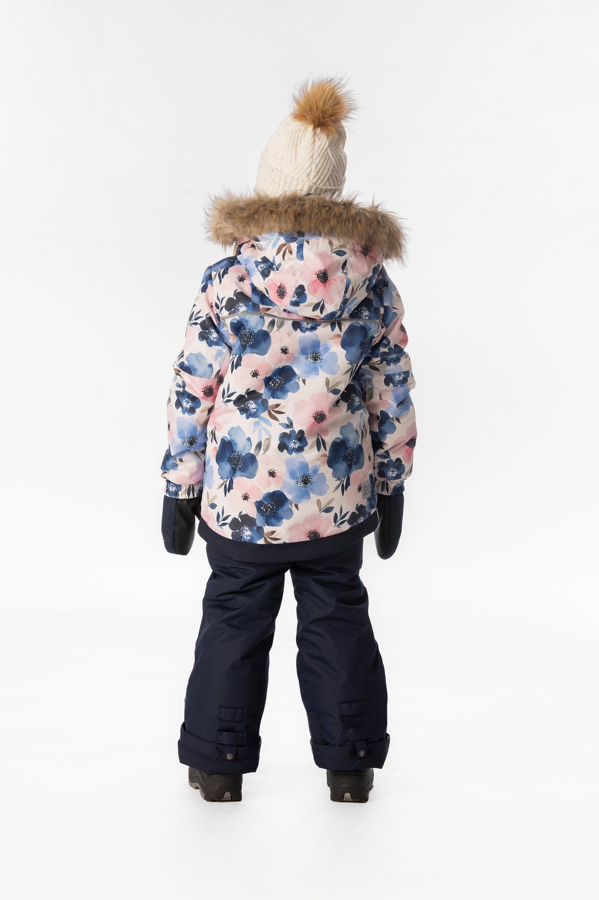 Back view of a girl in the watercolor flower Deux par Deux PLAY snowsuit