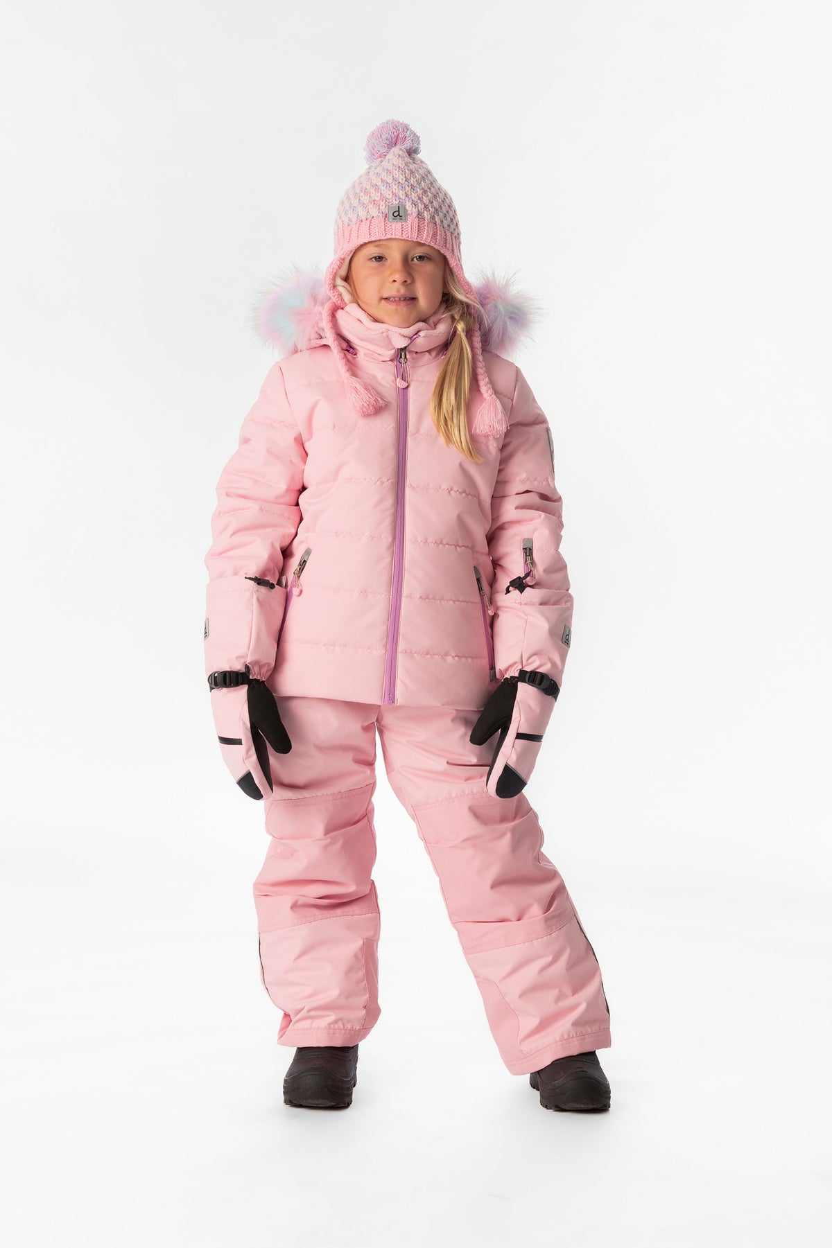 Girl standing in the light pink Deux par Deux PLAY snowsuit, full-length front view
