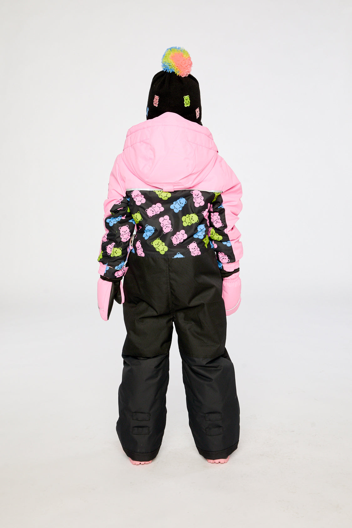 Kids PLAY pink and black gummy bear snowsuit shown in an alternate winter lookbook view