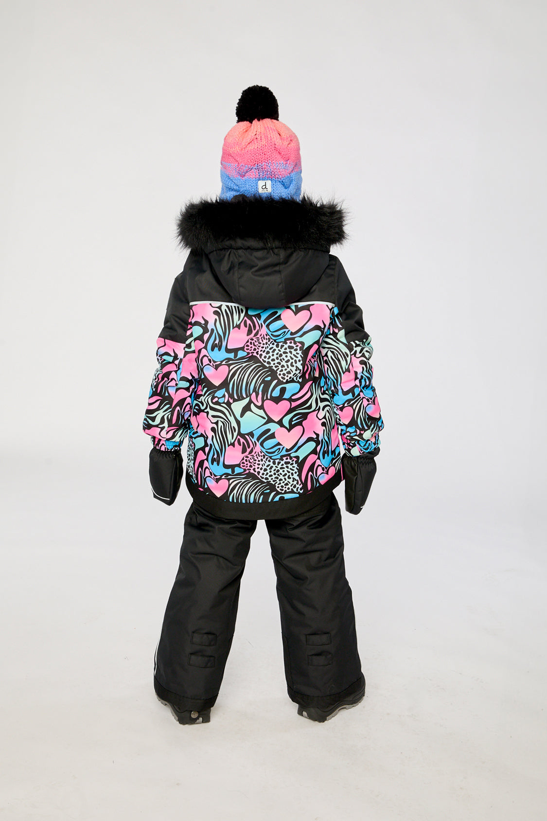 Girl in Deux par Deux -30°C black zebra snowsuit for skiing and winter snow play