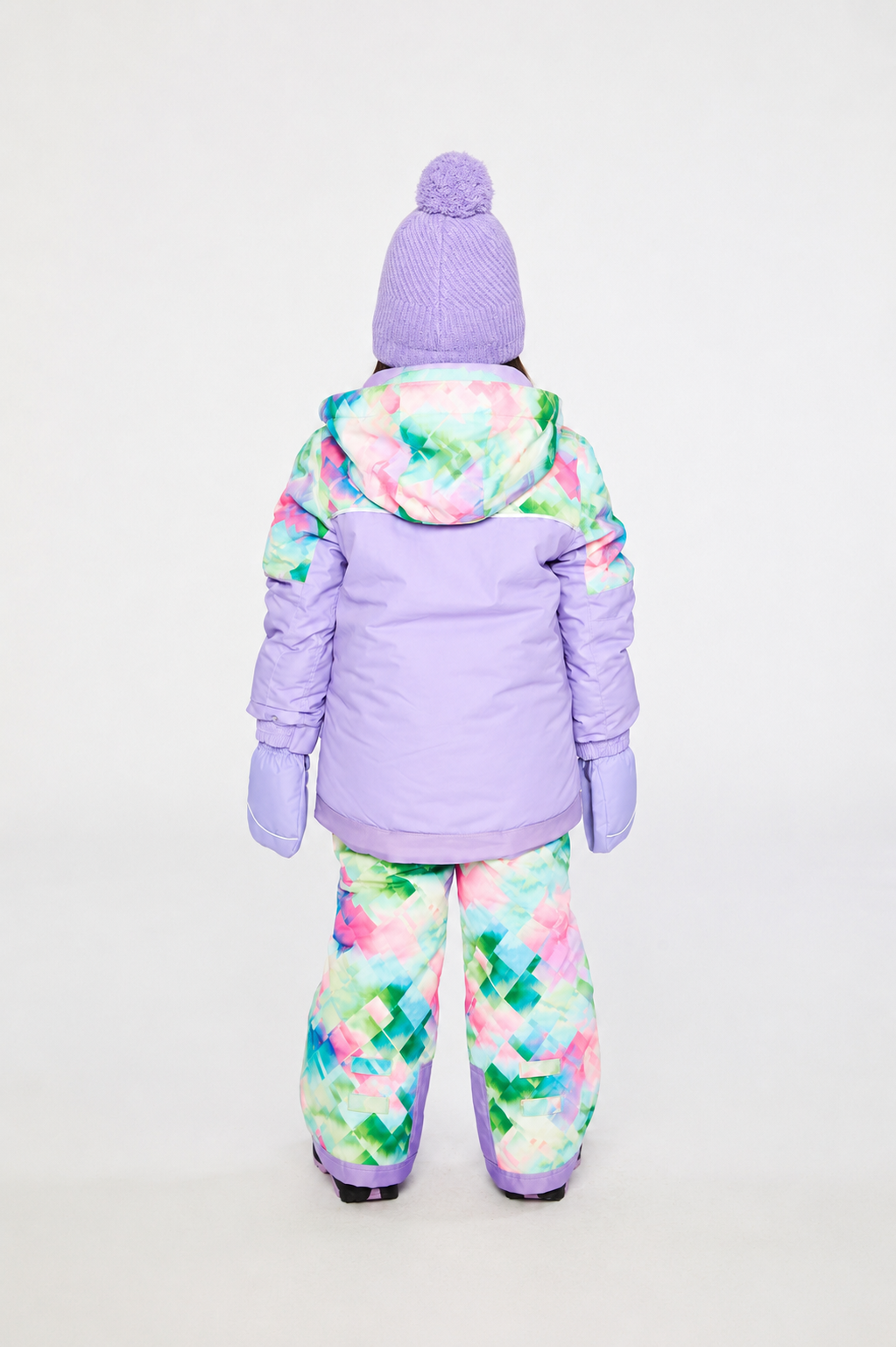 Back view of a child wearing the lavender snowsuit jacket with a diamond-print hood and matching patterned snow pants