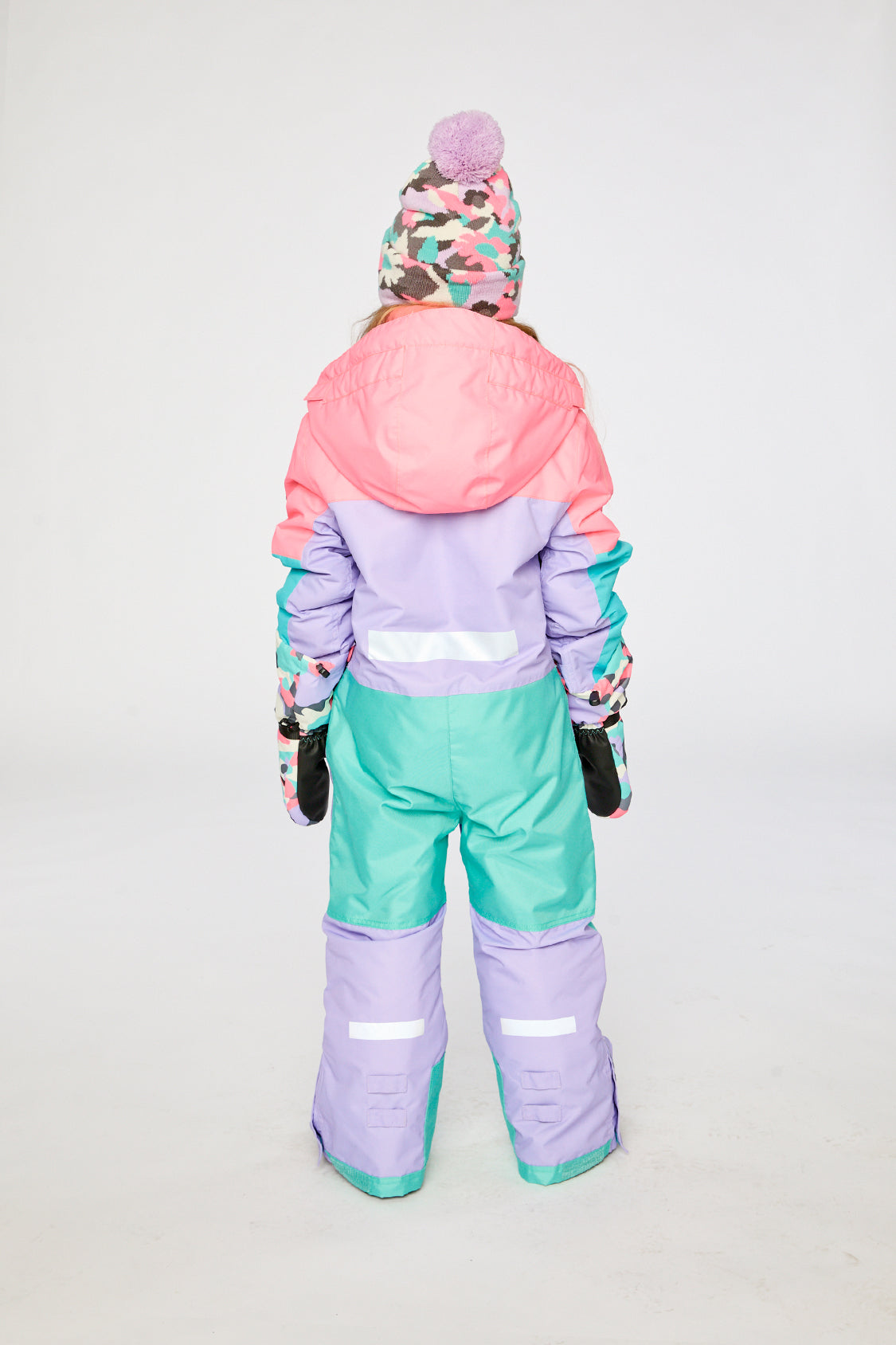 Kids TEKNIK snowsuit in lavender turquoise orange shown in an alternate winter lookbook view
