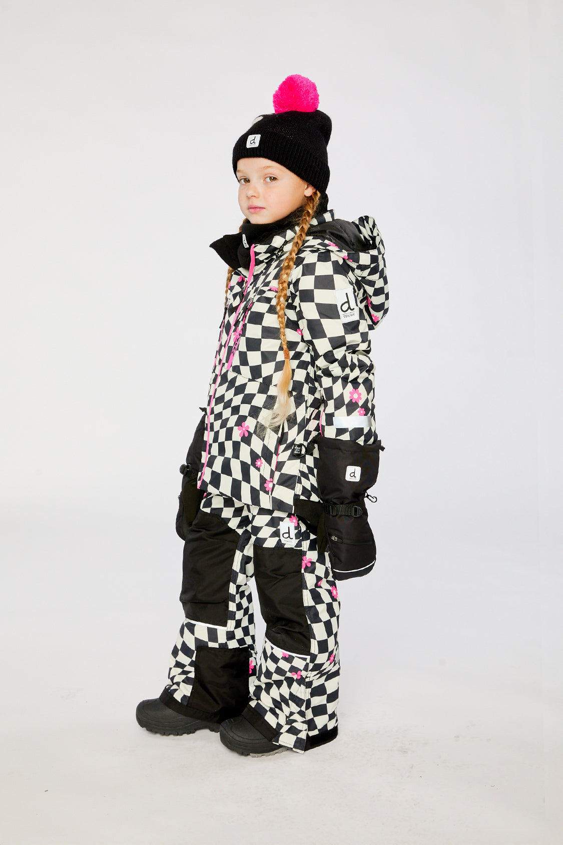 Deux par Deux TEKNIK two-piece snowsuit in White and Bright Pink Checkered Print shown from an alternate modeled winter angle