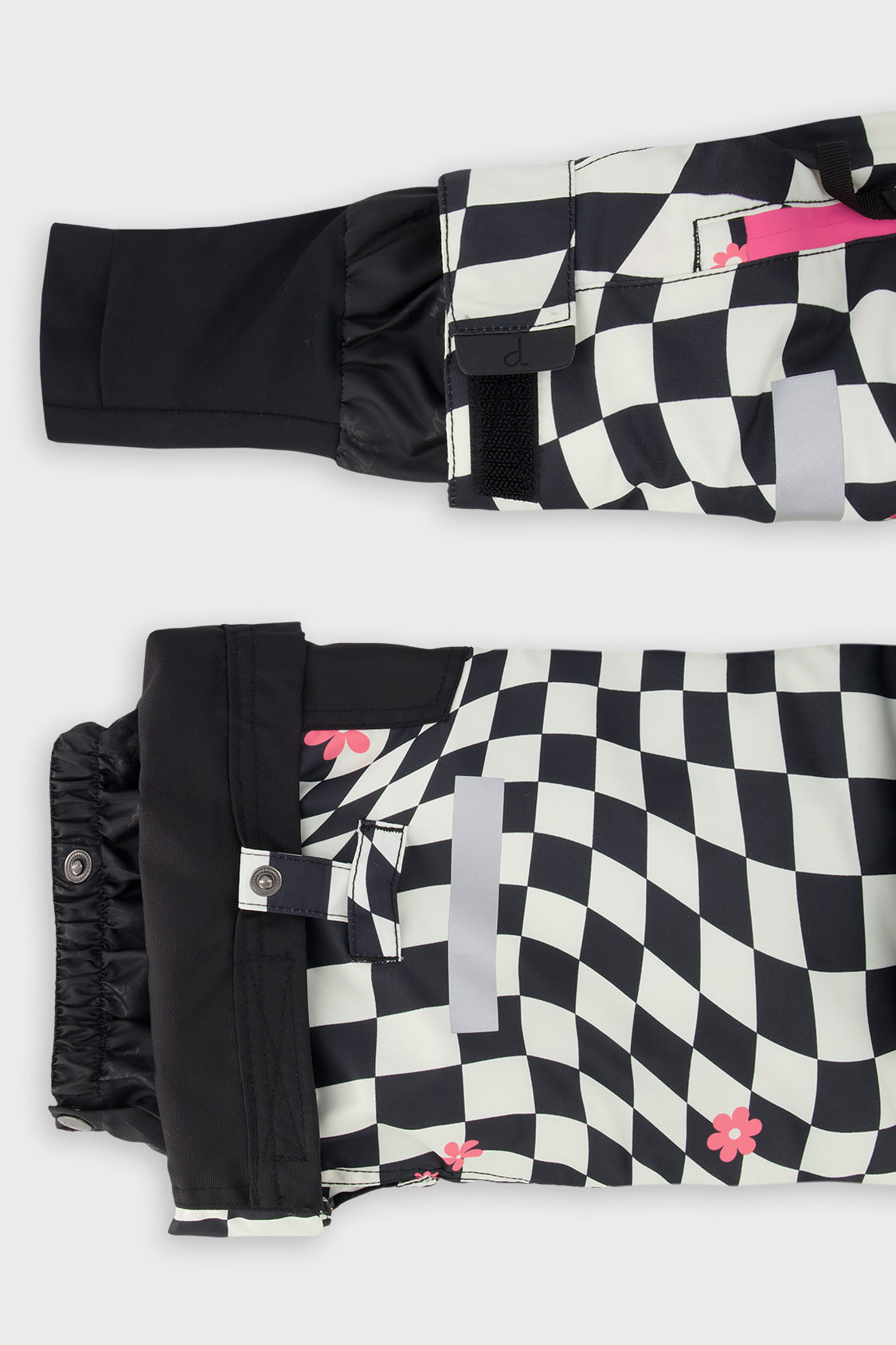 Close-up of the TEKNIK jacket cuff and the adjustable snow pant hem with snap tab
