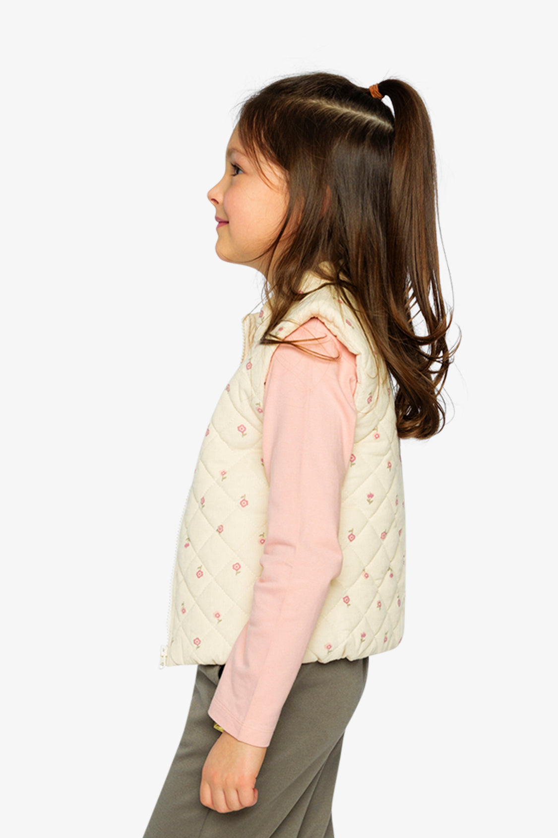 Lookbook photo of a child in the beige floral puffy vest by Deux par Deux