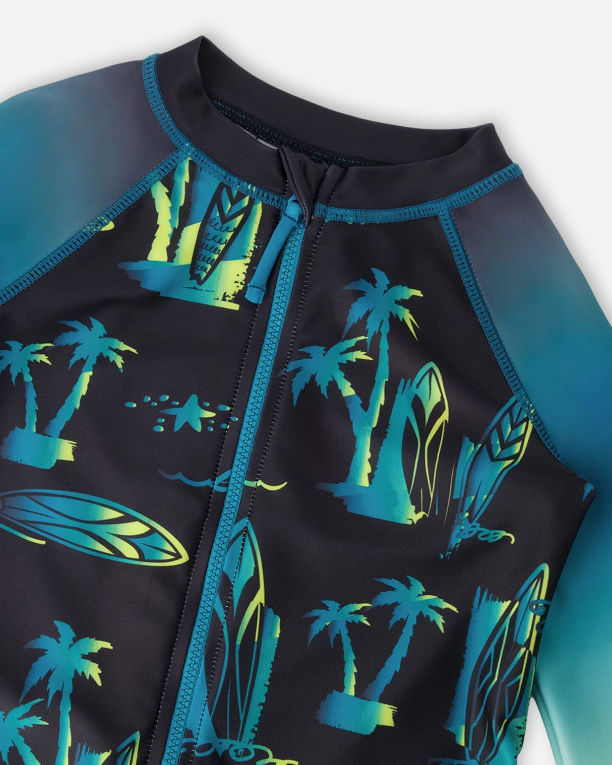 Close-up of zipper, neckline, and surf print details on black long sleeve rashguard swimsuit for baby boys