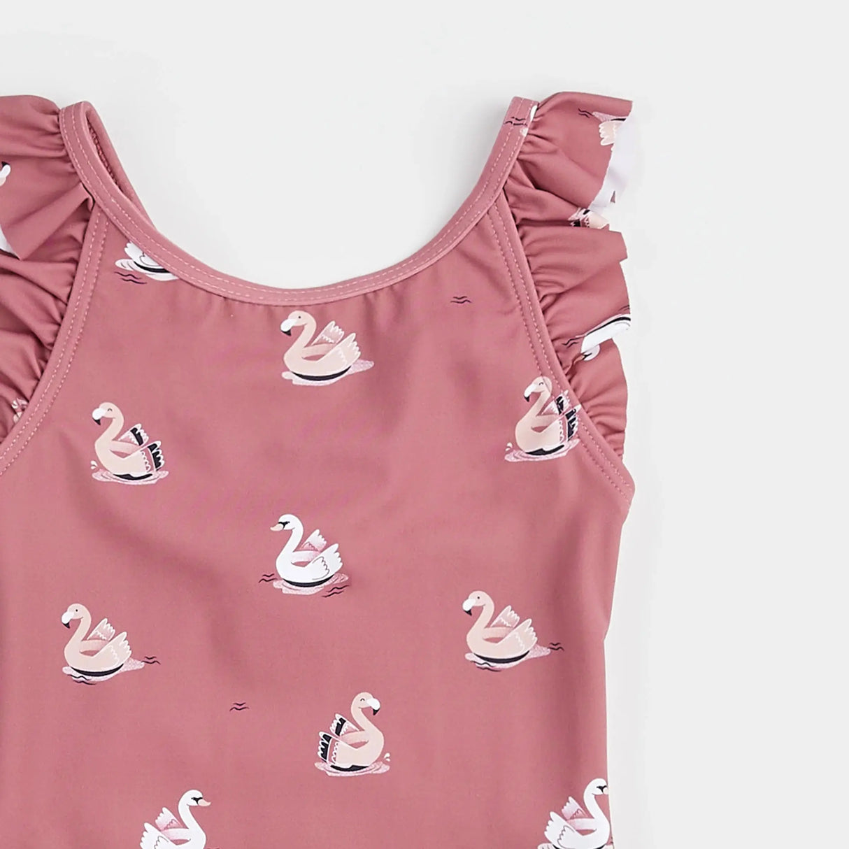 Close-up of swan balloon print and ruffled shoulder detail on jazzberry Petit Lem kids swimsuit