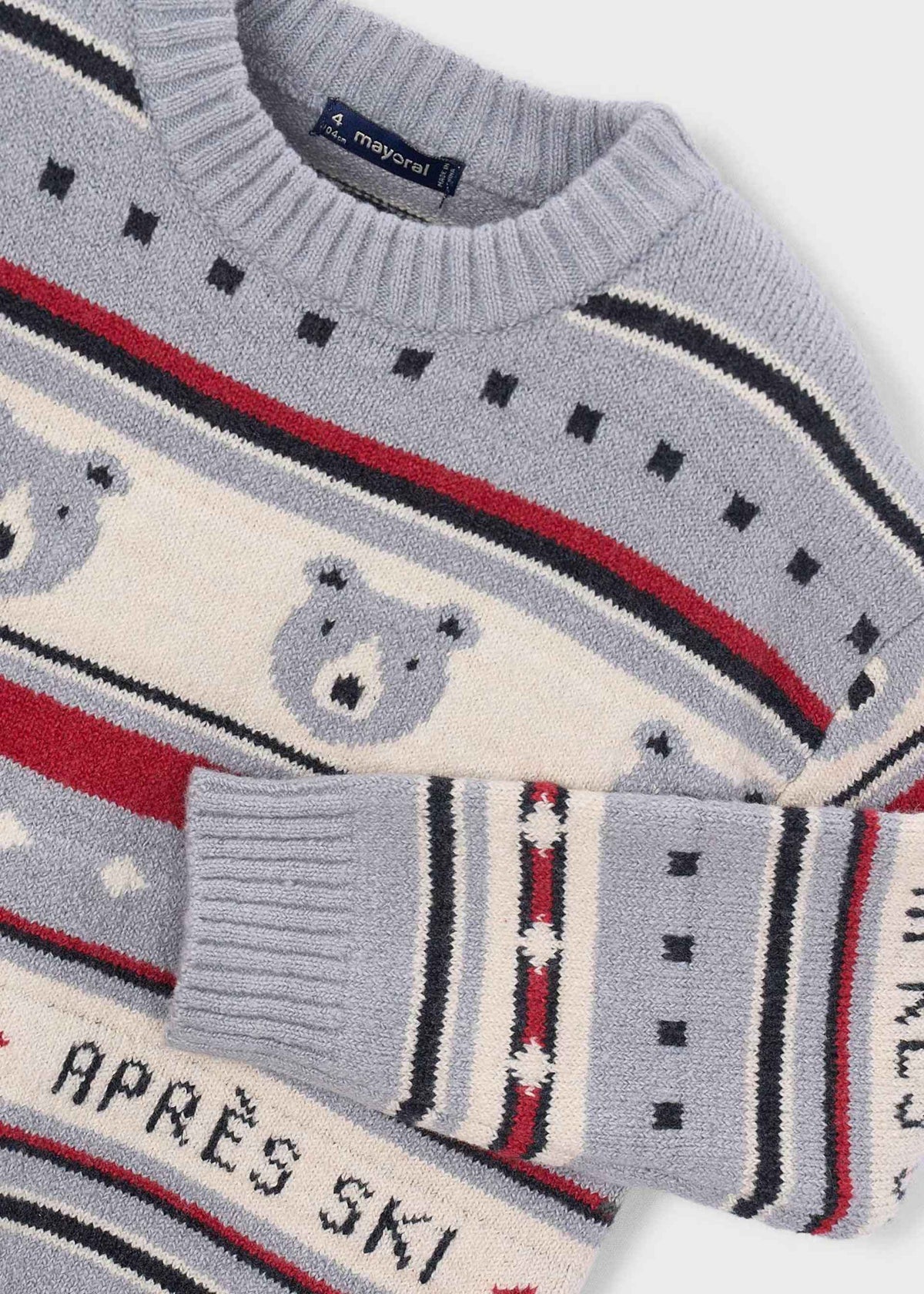 Close-up of polar bear motifs stripes and ribbed cuff on gray sweater
