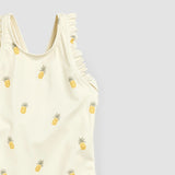Close-up of birch pineapple kids swimsuit fabric and soft frilly shoulder detail