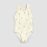 Front flat lay of Petit Lem birch one-piece swimsuit with yellow pineapple print and ruffled straps