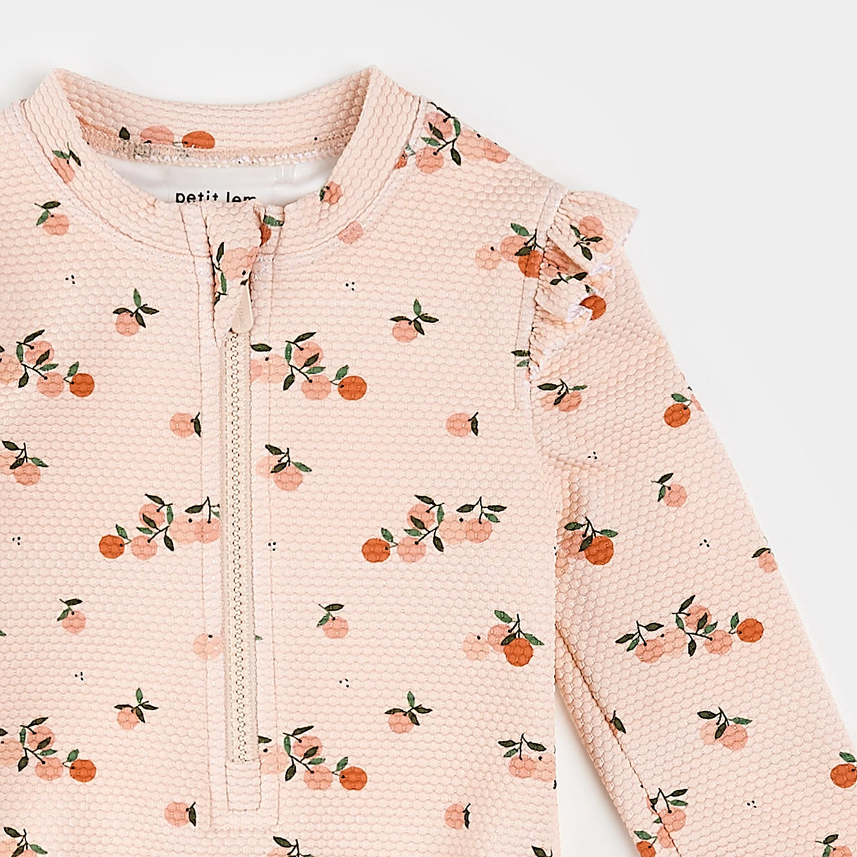 Petit Lem long sleeve baby swimsuit orange print close-up detail