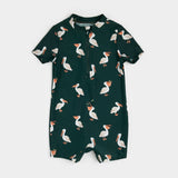 Deep sky pelican-print baby swim romper laid flat showing short sleeves and zipper front.