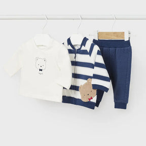 Flat lay of navy striped bear jacket ivory tee and joggers set