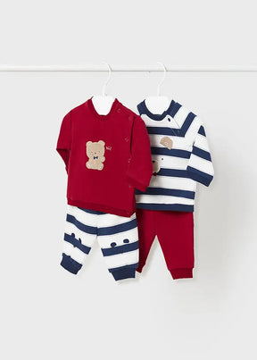 Flat lay of four-piece baby boys bear and dog sweatshirt and pant set