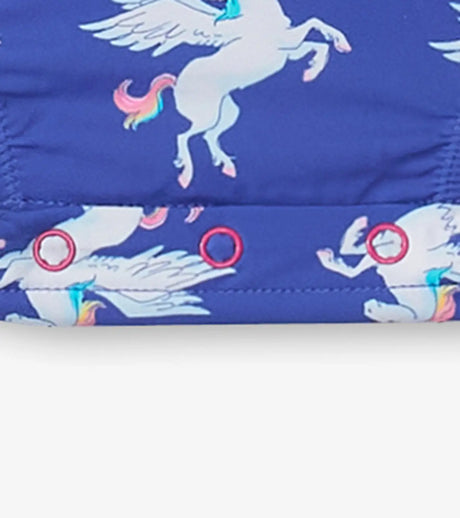 Side view detail of unicorn print and pink ruffle leg on baby girls swim bodysuit