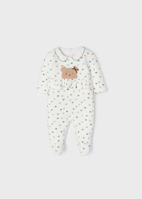 Front view of cream Mayoral baby girl footed romper with heart print and bear appliqué