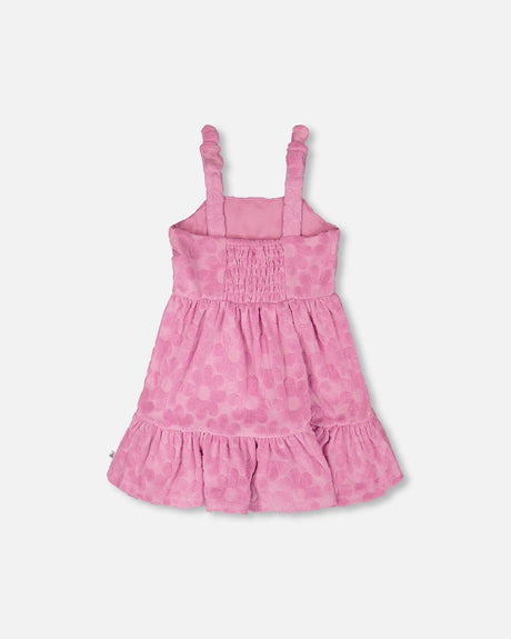 Back view of pink girl cover-up dress with knotted straps and tiered hem