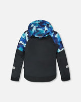 Back view of jacket and snow pants set with detachable hood and snow skirt, teal/blue camo.