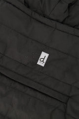 Close-up of the black quilted shell, zip pocket and logo tab