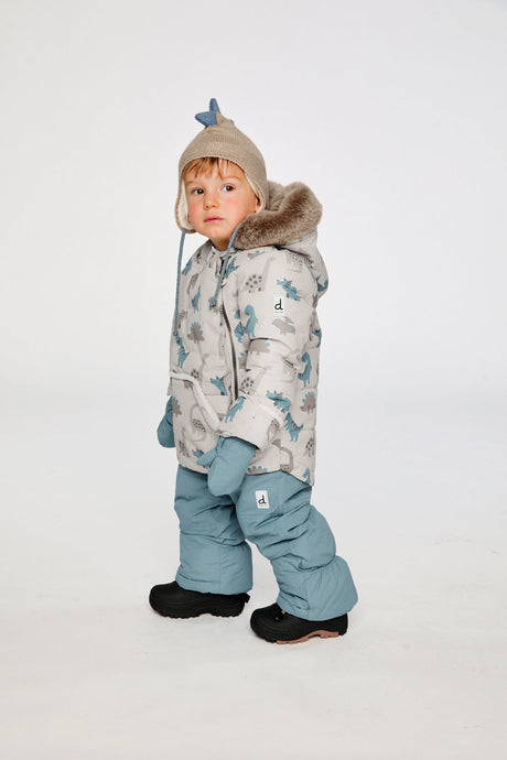 Deux par Deux baby two-piece snowsuit in Blue Dinosaur Print shown from an alternate modeled winter angle