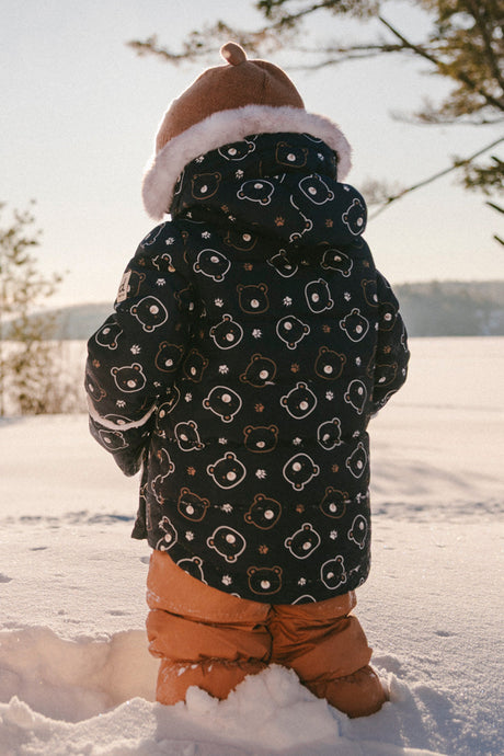 Deux par Deux baby two-piece snowsuit in Blue Printed Teddy Bears shown in an alternate outdoor winter lifestyle view
