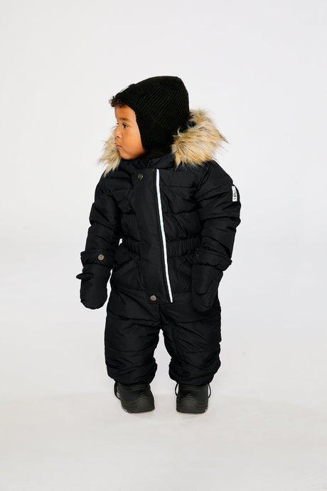Baby wearing the Deux par Deux Baby Original puffy one-piece snowsuit in Black in a winter lookbook view