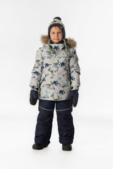 Boy standing in the grey dinosaur print Deux par Deux DISCOVER snowsuit, full-length front view