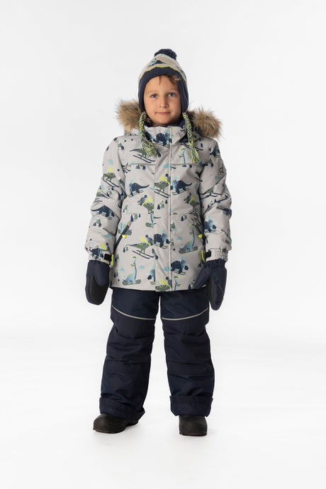 Boy standing in the grey dinosaur print Deux par Deux DISCOVER snowsuit, full-length front view