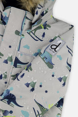 Deux par Deux boys DISCOVER snowsuit, grey dinosaur print – close-up of the water-repellent jacket shell and logo patch