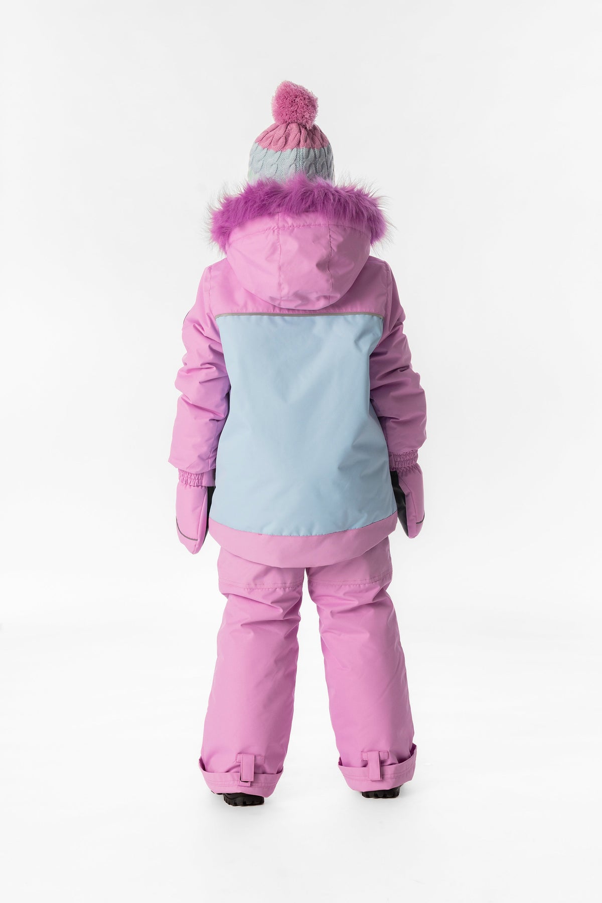 Girl in the pinkish violet colour-block Deux par Deux DISCOVER snowsuit, back view